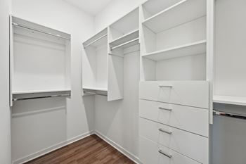A white closet with drawers and shelves.